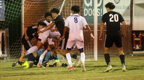 Columbia's defense corrals the ball to clear it away after goalkeeper Logan Wheeldon made a save during Wednesday's win over Suwannee. (PAUL BUCHANAN/Lake City Reporter)