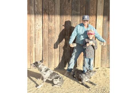 Jared and Harper Lee show off their world championship buckles won at the Ericsson Memorial trials in Texas. Harper Lee won the youth division with Rainbow, while Jared Lee won the futurity championship and open reserve with Kong. (COURTESY)