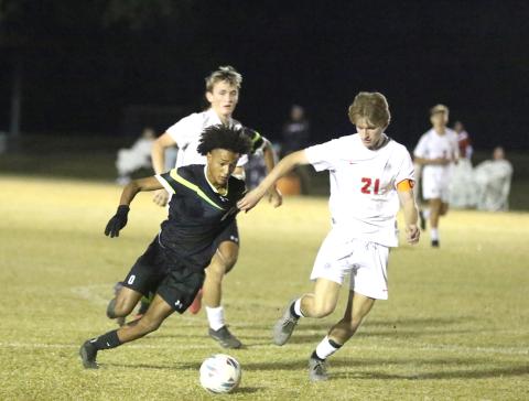 Columbia forward Colyn Weatherspoon is grabbed by Santa Fe defender Mason Kramer during Tuesday's 2-1 loss. (MORGAN MCMULLEN/Lake City Reporter)
