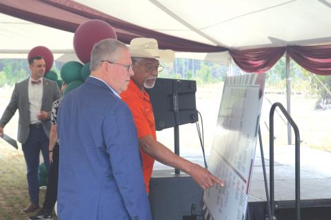 Former Columbia County Commissioner Ron Williams (right) points out a moment on the timeline of the North Florida Mega Industrial Park to Rep. Chuck Brannan during Thursday’s celebration. (TONY BRITT/Lake City Reporter)