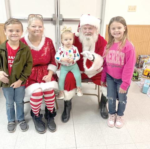 Santa and Mrs. Claus visit with children during the Breakfast with Santa event in Fort White on Saturday. (COURTESY)