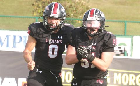 Fort White defensive lineman Ethan Shaw (51) celebrates after his fumble recovery alongside defensive back Ezekiel Powell (0) during the Indians’ 32-29 win over Port St. Joe in the FIT championship on Dec. 5. (MORGAN MCMULLEN/Lake City Reporter)