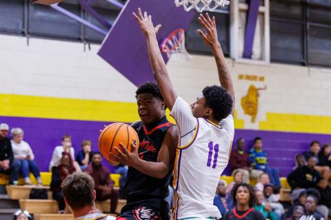 Fort White guard X’Zaevion Gibson drives to the basket while defended by Union County center Adrian Manns on Friday. (JACK HOWDESHELL/Lake City Reporter)