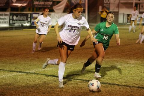 Columbia's Laelle Thompson dribbles the ball up the field as Suwannee's Maylee Grantham pursues her on Nov. 20. (PAUL BUCHANAN/Lake City Reporter)