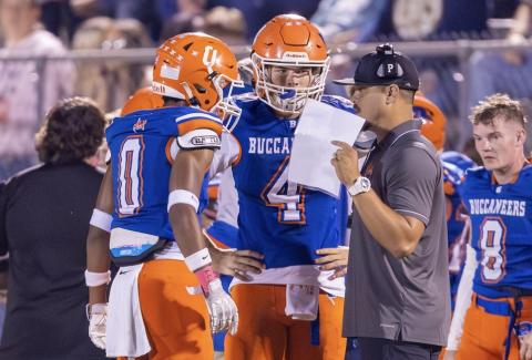 Branford coach Tim Clark (right) speaks to quarterback Trent Land (4) and receiver Maurice Vought (0) during a game this past season. (JACK HOWDESHELL/Lake City Reporter)