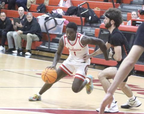 Fort White guard Jayden Jackson dribbles past Trenton forward Nathan Ridgell during Tuesday's 59-34 loss. (MORGAN MCMULLEN/Lake City Reporter)