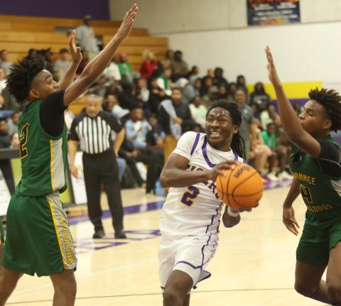 Columbia guard Kadrian Wilson drives between Suwannee guards Jalen Hampton (2) and Kamarien Smith (4) on Dec. 12. (PAUL BUCHANAN/Lake City Reporter)
