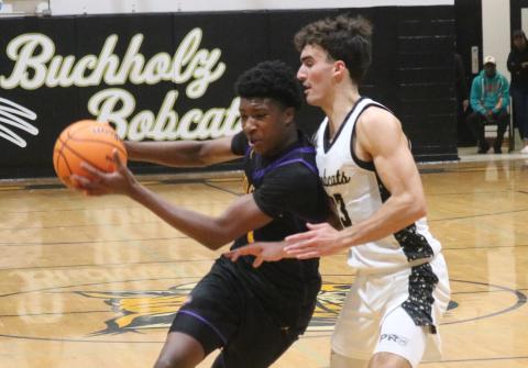 Columbia guard Shaheed White is guarded tightly by Buchholz forward Jamison Mctureous as he drives to the basket on Tuesday. (JORDAN KROEGER/Lake City Reporter)