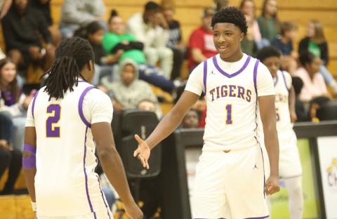 Columbia guards Kadrian Wilson (2) and Shaheed White (1) celebrate during the Tigers' win over Suwannee on Dec. 12. (PAUL BUCHANAN/Lake City Reporter)