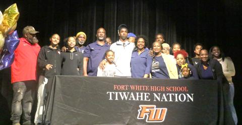Fort White defensive back Jayden Jackson (center) is surrounded by friends and family after his signing day ceremony Thursday. (MORGAN MCMULLEN/Lake City Reporter)