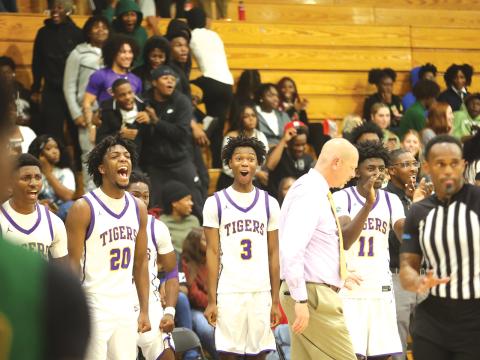 The Columbia bench, alongside coach Steve Faulkner, reacts to a play during the Tigers’ 72-45 win over Suwannee on Dec. 12. CHS wrapped up its weekend at the Holiday Hoopfest in Fort Myers with a 2-1 record, beating Gateway Charter and Mater Academy Charter. (PAUL BUCHANAN/Lake City Reporter)