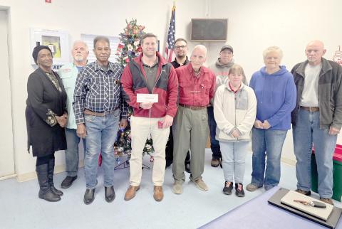 The Wellborn Community Association donated last week toward a scholarship fund at RIVEROAK Technical College to help students pursue Career and Technical Education degrees and certificates. Presenting the check to RTC Principal Clay Tomlinson were Fran Martin (from left), Sherm Stanley, Mayso Martin, Tomlinson, Austin Little, Bob Huffman, Pedro Faria, Lynn King, Pam Mikitta and Bill Muller. (MONJA SLATER/Lake City Reporter)