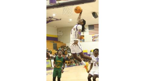 Columbia guard Kadrian Wilson flies through the lane for a dunk against Suwannee on Friday. (PAUL BUCHANAN/Lake City Reporter)