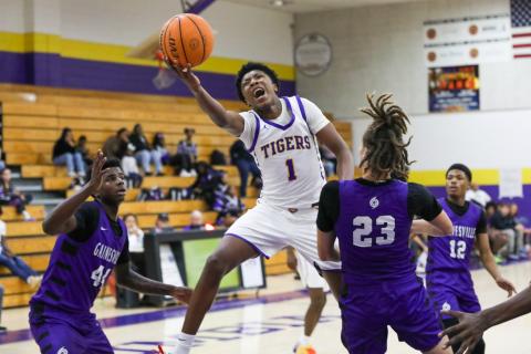 Columbia guard Shaheed White tries to get around Gainesville center Aiden Raney for a layup on Tuesday. (BRENT KUYKENDALL/Lake City Reporter)