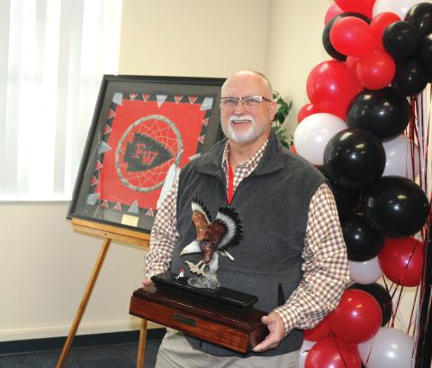 Former Fort White High School principal Keith Hatcher holds a ceremonial eagle plaque at his retirement party. Hatcher served as the high school’s first principal. (TONY BRITT/Lake City Reporter)