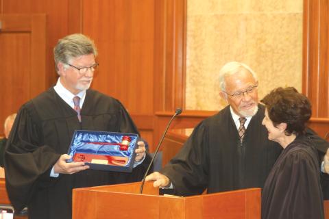 Third Circuit Judge Gregory Parker (from left) and retired Circuit Judge David Fina present retiring Third Circuit Judge Leandra Johnson with a ceremonial gavel during her retirement ceremony Friday. (TONY BRITT/Lake City Reporter)