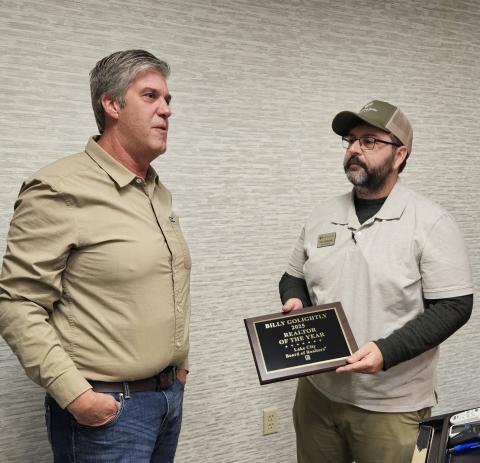 Billy Golightly (right), the broker and co-owner of Lands of North Florida Realty, receives the Lake City Board of Realtors’ Realtor of the Year award Wednesday from Brad Dicks, last year’s winner. (COURTESY)