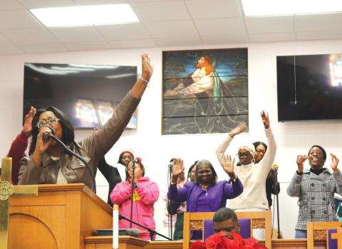 LaJoyce Ingraham (left) leads a song during the MLK Church service on Monday afternoon at New Mt. Pisgah AME Church. The service took place immediately following the MLK parade. (TONY BRITT/Lake City Reporter)
