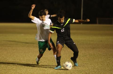 Columbia's Josiah Hopkins tries to maintain possession as Suwannee's Aksel Perez gives chase on Dec. 1. (PAUL BUCHANAN/Lake City Reporter)