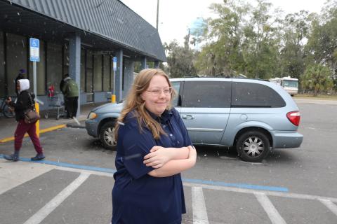 Natalie Fannon, a cashier at Save A Lot In Lake City, checks out the snow flurries that blew through North Florida on Saturday afternoon. (TONY BRITT/Lake City Reporter)