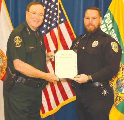 Polk County Sheriff Grady Judd (left) presents a Sheriff’s Commendation award to Lake City Police Department Detective Richard Poteat for his efforts in Operation Child Protector VII, which resulted in the arrest of a Montana man. (COURTESY LAKE CITY POLICE DEPARTMENT)