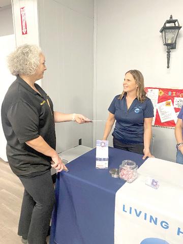 Barbara Etter, community services coordinator with Living Hope, speaks to Columbia County Chief Deputy Katina Dicks at a local event. (COURTESY)