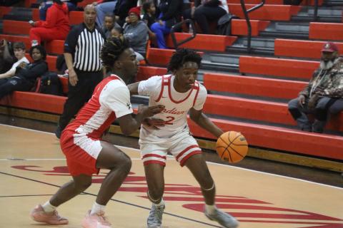 Fort White guard Desean Lally drives against Bradford's Jordan Cason during Tuesday's 43-24 loss. (MORGAN MCMULLEN/Lake City Reporter)