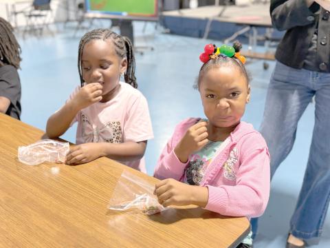 Minnie J. Niblack Elementary students A’mari and Rylee try edamame for the first time during a taste test at the end of the Serving Up MyPlate lesson. (COURTESY UF/IFAS EXTENSION COLUMBIA COUNTY)
