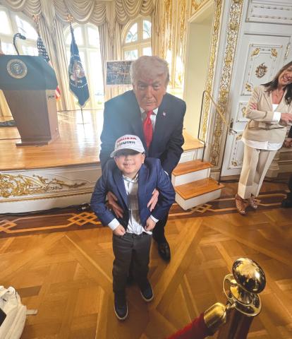 Rep. Chuck Brannan’s son, Rafe, is held by President Donald Trump during Friday’s ceremony. (COURTESY)