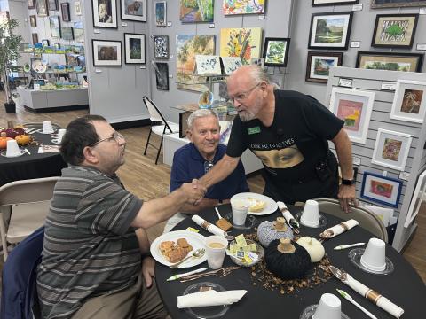 Gateway Art Gallery artist and Navy veteran Benjamin Ragland (right) greets military veterans Richard Raposo and Russell Fulmer from the Robert H. Jenkins Jr. Domiciliary at a previous presentation at the Gallery. (COURTESY)