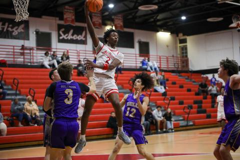 Fort White guard Desean Lally throws a pass during Tuesday's District 6-R quarterfinal against Bell. (BRENT KUYKENDALL/Lake City Reporter)