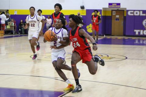 Columbia guard Kadrian Wilson drives to the basket while tightly guarded by Leon forward Keon Green during the District 2-5A semifinals on Feb. 5. (BRENT KUYKENDALL/Lake City Reporter)