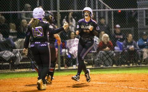 Columbia catcher Emily Delgado celebrates as she scores a run against Fort White last season. Delgado returns behind the plate this year for the Tigers. (FILE)