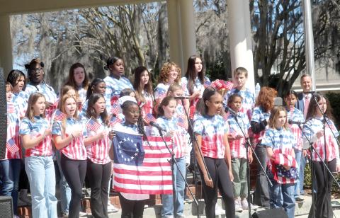 Richardson Sixth Grade Academy students from the school’s chorus and theatre program sing a song during a skit at the local 250th Birthday Party for America kickoff celebration on Tuesday morning. The event was attended by more than 200 people. (TONY BRITT/Lake City Reporter)