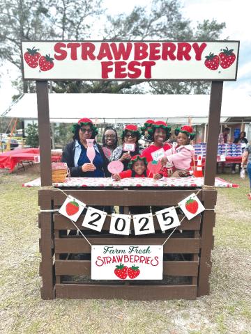 A family poses for a pic at the photo station during last year’s Live Oak Strawberry Festival. This year’s festival begins at 10 a.m. Saturday at the Suwannee County Fairgrounds in Live Oak. (COURTESY)