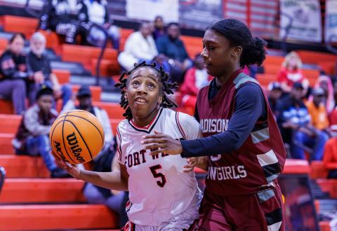 Fort White guard Javiona Roberson drives to the rim against Madison County's Tahj Dobson during Friday's Region 3-R semifinal. (JACK HOWDESHELL/Lake City Reporter)