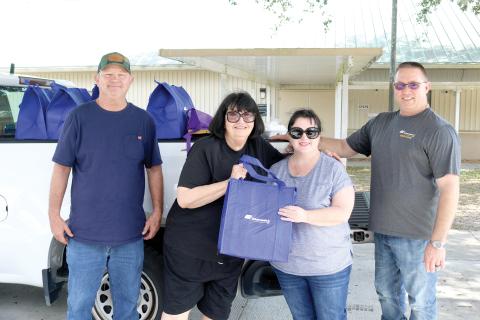 Pat Mundorff (from left) helped out Alice Martin alongside Candi Kish and Todd Martin during the Law family fundraiser. (TONY BRITT/Lake City Reporter)