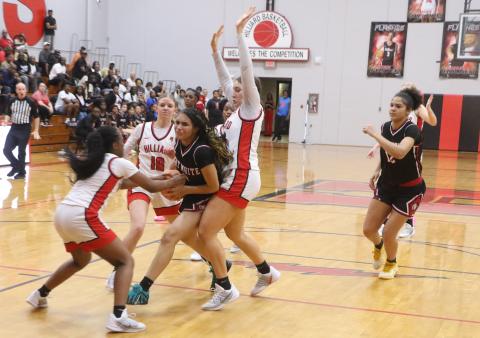 Fort White guard Mariah Cox (1) is swarmed by Hilliard defenders during Friday's 56-37 loss in the Region 3-R finals. (MORGAN MCMULLEN/Lake City Reporter)