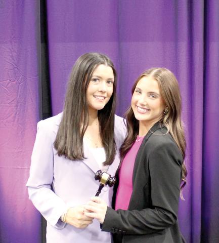 Lyla Folsom (right), Columbia High Student Government Association’s represenative, receives the gavel from Gainesville High’s Macy Gleason as CHS is now the Florida Association of Student Councils District 2 president. Gleason and GHS held the position the past year. (COURTESY)