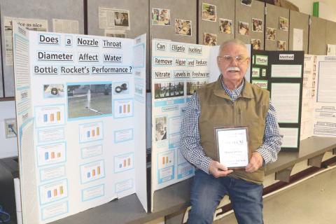 Fort White Middle School science teacher Wayne Oelfke holds his plaque after being named the University of Florida Chapter Sigma Xi Teacher of the Year Award winner (TONY BRITT/Lake City Reporter)