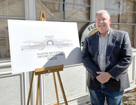 Rep. Chuck Brannan is pictured next to a rendering of the new Olustee Battlefield Historic State Park museum during the groundbreaking ceremony Friday at the park. (COURTESY)