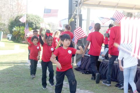 North Florida Arts & Sciences Academy students wave American flags at last year’s Olustee Festival. This year’s festival theme is Celebrate America in honor of the semiquincentennial. (FILE)