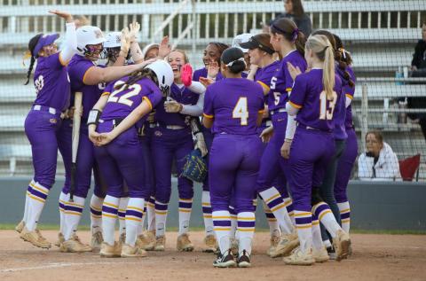 Columbia catcher Emily Delgado (22) is greeted at home plate by her teammates after hitting a two-run home run against Bartram Trail on Thursday. (BRENT KUYKENDALL/Lake City Reporter)