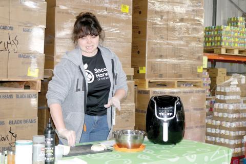Merrick Mitchell, a nutrition educator, prepares turnips during a food demonstration at Catholic Charities on Wednesday, kicking off its annual March against Hunger campaign. (TONY BRITT/Lake City Reporter)