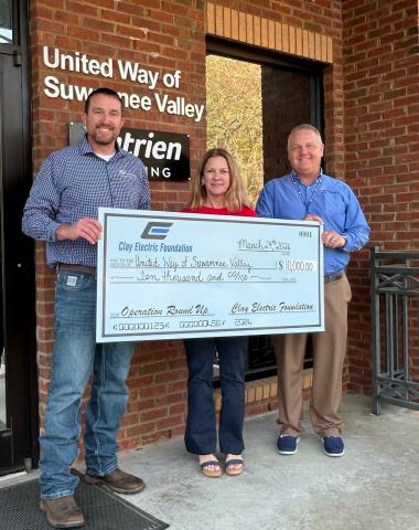 United Way of Suwannee Valley Executive Director Jennifer Anchors receives the $10,000 contribution from the Clay Electric Foundation from Jordan Wade, member relations representative (left), and District Manager Troy Adams. (COURTESY)