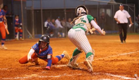 Branford right fielder Aurelia Darling slides safely into home plate past Suwannee catcher Addison Peterson on Thursday. (PAUL BUCHANAN/Lake City Reporter)
