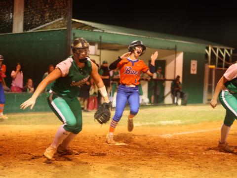 Branford pinch runner Payton Bates scores the tying run as Suwannee's Felicity May chases the ball on Monday. (PAUL BUCHANAN/Lake City Reporter)