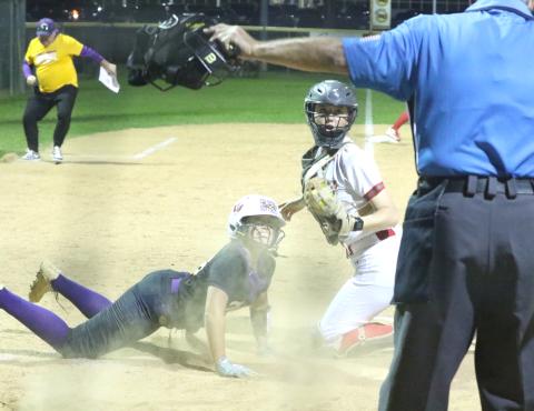 Columbia center fielder Luisa Taylor (left) and Santa Fe catcher Ainslea Kelsoe react to a safe call from the umpire during the Tigers' 13-2 loss Tuesday. (MORGAN MCMULLEN/Lake City Reporter)