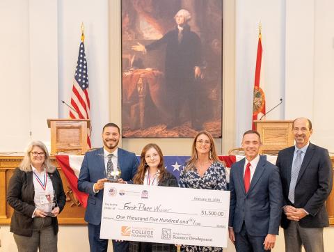 North Florida College student Lillian Clay, of Suwannee County, holds the winning check after winning the inaugural Sunshine State Debate. Florida Commissioner of Education Anastasios Kamoutsas stands to her left, holding the trophy Clay won. (COURTESY NORTH FLORIDA COLLEGE)