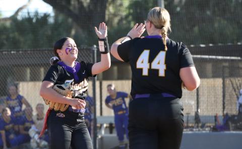 Columbia pitcher Kinley King (left) high fives third baseman Josie Raulerson after finishing off an inning against Palatka on Friday. (BRENT KUYKENDALL/Lake City Reporter)